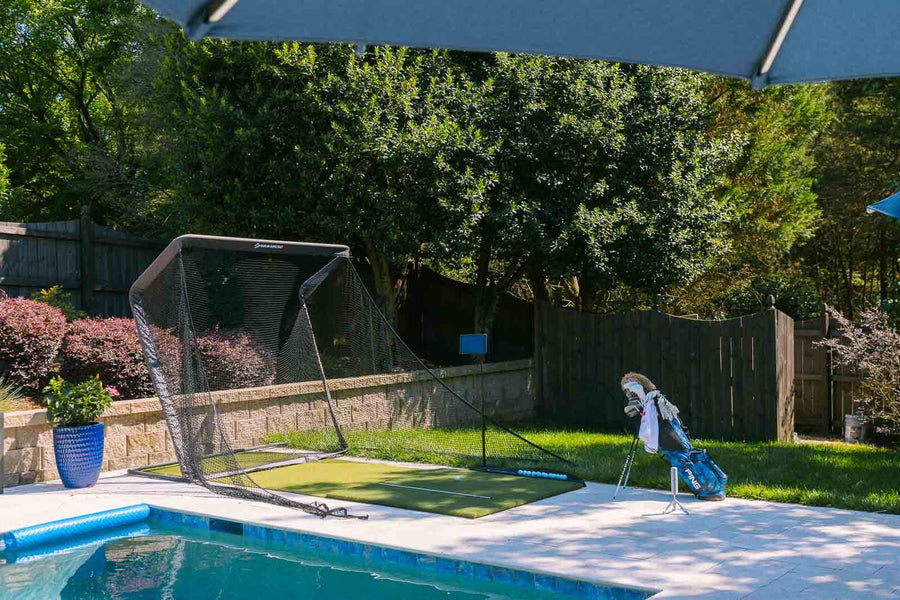 Outdoor golf simulator practice setup in a backyard